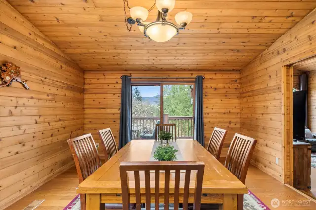 Dining room that includes access to one of the home's decks that overlook the rest of the property.