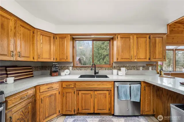 Updated countertops and backsplash in the large kitchen that overlooks dining room and living room.
