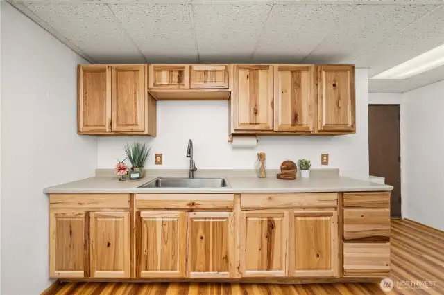 Beautiful natural wood cabinets throughout lower level kitchenette and bathroom.