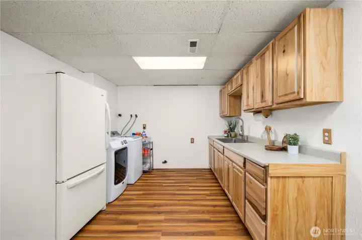 Lower level kitchenette and laundry area. Fully updated cabinets and countertop.