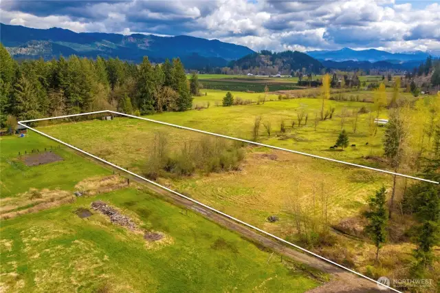 Photo showing both pastures with approximate property boundaries. Approximately 2 acres of fully fenced pasture and another 1 acre of partially fenced pasture with the creek separating.
