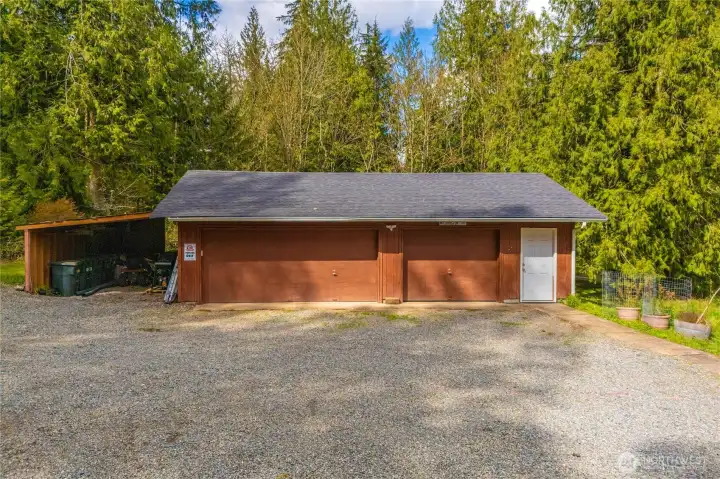 Roughly 900 sq foot detached 3 car garage with additional carport parking/storage.