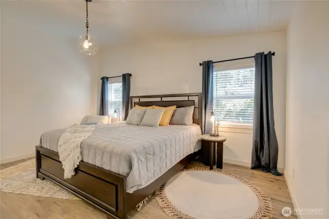 Spacious master bedroom with a vaulted ceiling, adding an open airy feel.