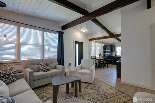 Spacious living room with wood beams.