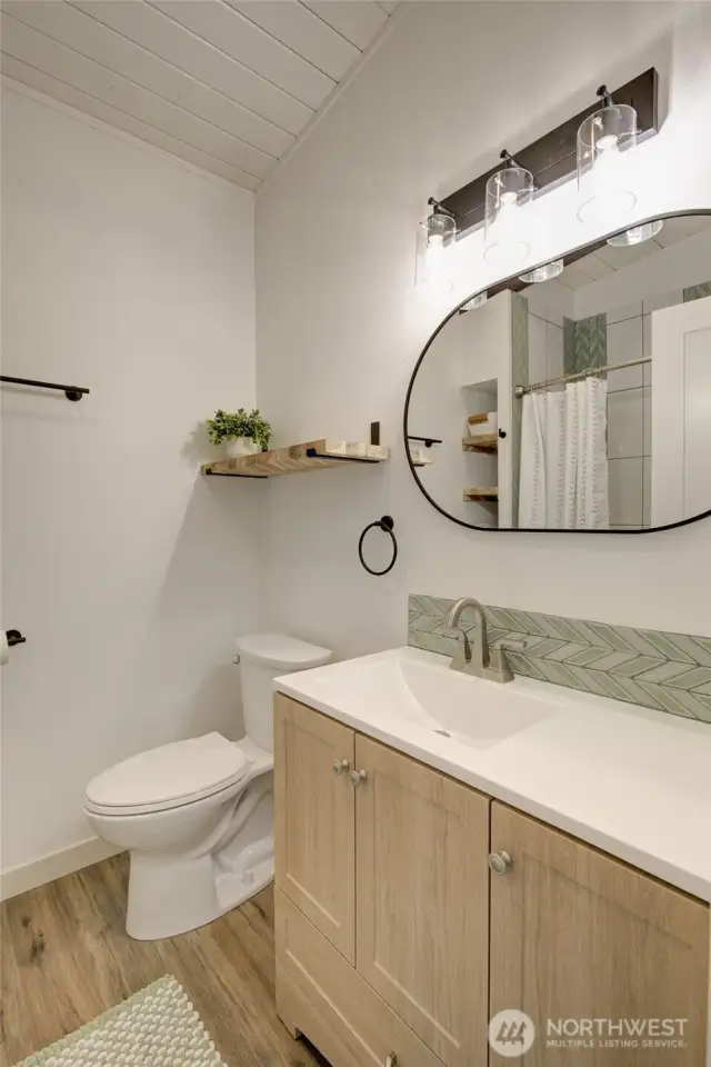 Main bathroom features a tile backsplash for a clean modern look.