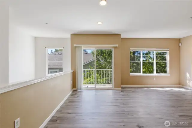 Ideal gathering space for friends and family with room for a full-sized dining table. A slider opens to the balcony.