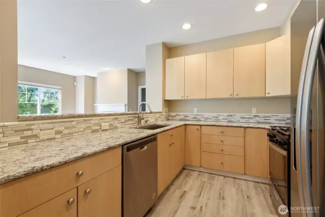 Stunning quartz countertops for a sleek look and elegant tile backsplash for a designer touch.