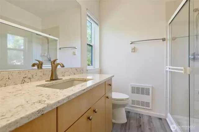 Primary bath with quartz countertops.