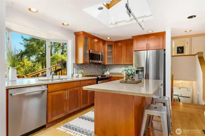 pen cherry kitchen with granite and stainless steel appliances.
