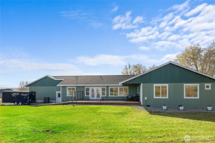 View of the back of the home with deck.