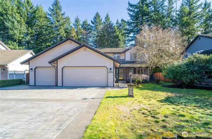 Front view of nice yard and 3 car garage