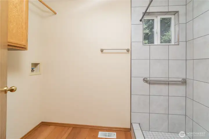 Laundry room off of garage entry with large tile walk in shower