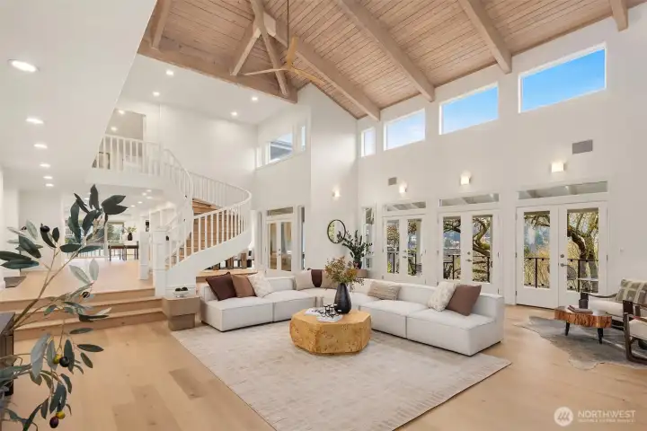 Grand in scale and design—25’ wood-beamed ceilings with twin 84” fans, a reclaimed timber mantel illuminated by remote-controlled LED lighting, and four double doors that open seamlessly to a 65’ veranda.