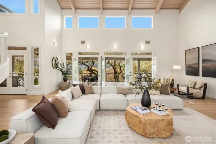 Four sets of double doors dissolve into a 65’ veranda with sweeping Puget Sound views—watching ships pass through the Ballard Locks below.