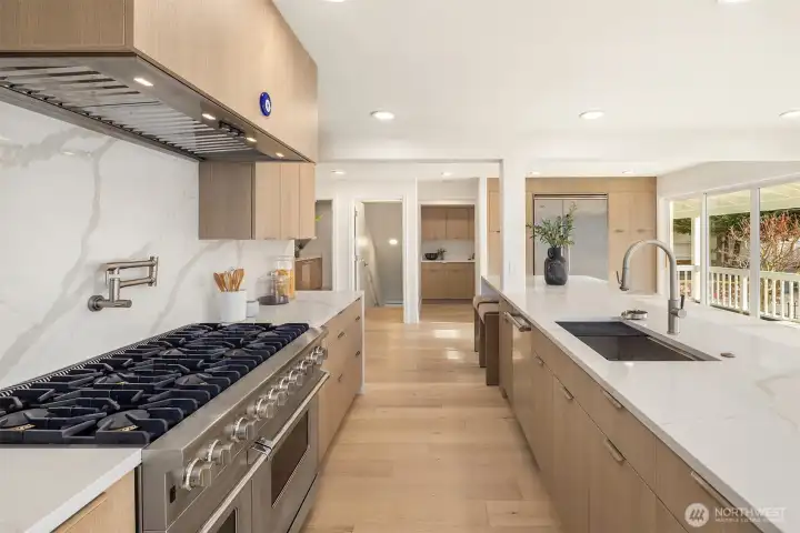 A true chef’s kitchen anchored by a 14’ island with recessed power and charging, paired with an exceptional Viking suite including dual refrigerator/freezers and a 48” range with double ovens.