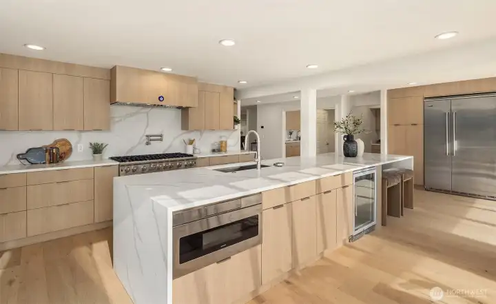 Designed for effortless entertaining with a sprawling 14’ counter, dedicated space for a wine or beverage fridge, and thoughtful conveniences including a bottle cleaner and disposal.