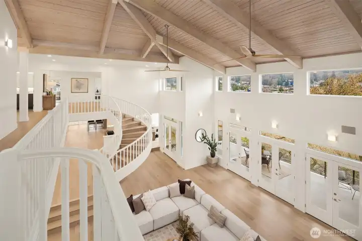 A statement spiral staircase and 25-foot wood-beam ceilings create a showstopping impression—truly even more stunning in person.