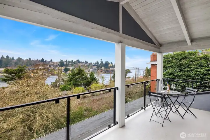 A private balcony extends from the primary suite, offering panoramic Sound views—sunrises sparkling on the water and city lights dancing after dusk.
