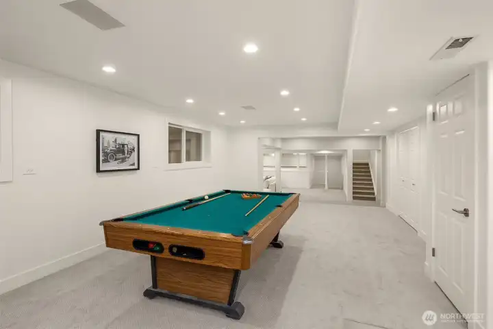 Curated for refined recreation, the lower level features space for a full-size billiards table, foosball, a substantial lounge area, and a thoughtfully designed kitchenette