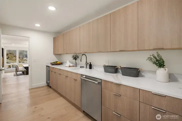 Tucked just off the main kitchen, the kitchenette is ideal for a nanny suite, office support, coffee bar, or a hidden wet bar.