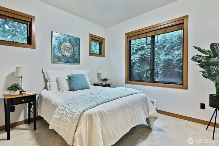 Main floor bedroom looks into the trees.