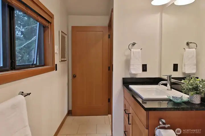 Primary bath looks out to private backyard area.