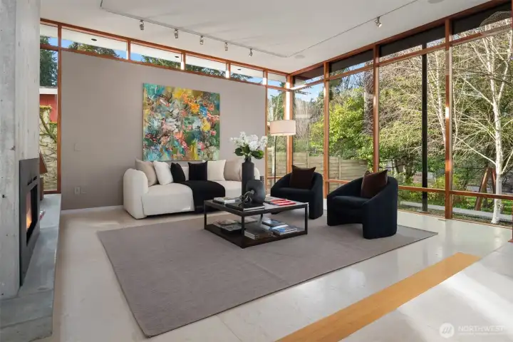 Wrapped in glass, the living space enjoys two cinematic outlooks: one to the courtyard and lawn, the other to a birch-lined, park-like setting that feels borrowed from the Arboretum itself.