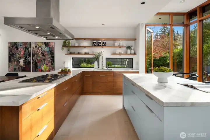 At the heart of the main level, the kitchen performs like a showpiece—and like a workhorse. Calacatta marble slabs top custom walnut cabinetry, paired with Gaggenau cooking appliances, a newer Thermador refrigerator, and a newer Miele dishwasher, and the space opens beautifully to the backyard for effortless indoor-outdoor entertaining.   for elevated everyday living and entertaining.