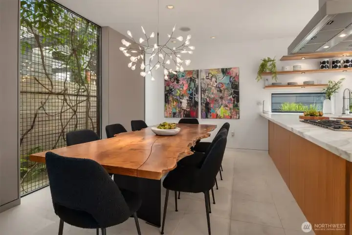 The “green window”: A signature design element—metal grid cladding supports  evergreen clematis for privacy while filtering light into the dining area, creating a living  screen that changes with the seasons.