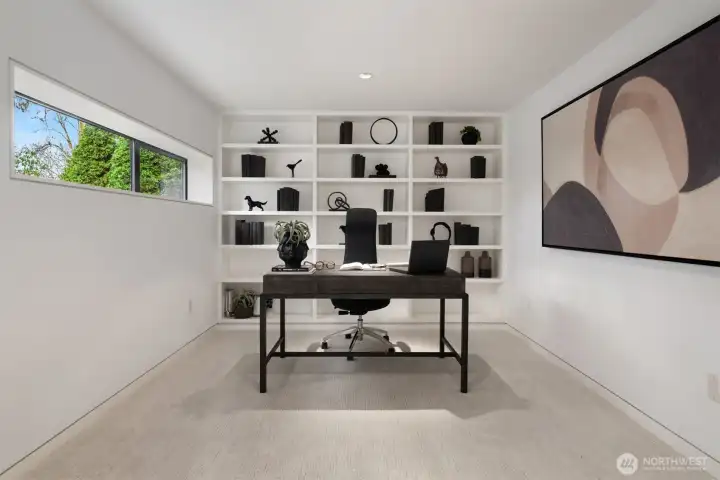An open office/flex space just off the living room adds everyday functionality without interrupting the home’s gallery-like flow—ideal for work-from-home, studying, or a quiet reading lounge.