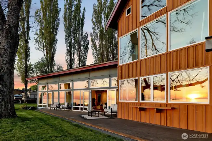 A deck runs the entire front of the home