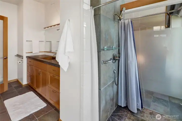 The main level primary bath has a custom glass shower