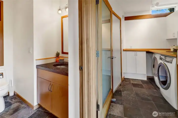 Easy access from the mudroom to the half-bathroom and utility room