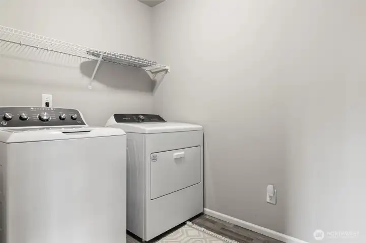 Laundry room with hidden storage space.