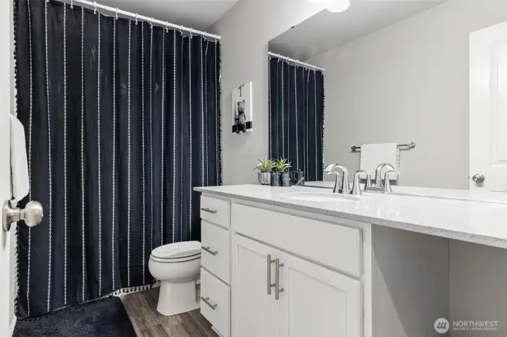 Hallway bathroom with large counter space.