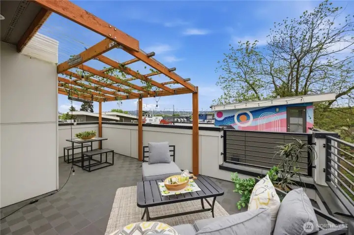 Spacious rooftop deck. Flooring installed and covered pergola.