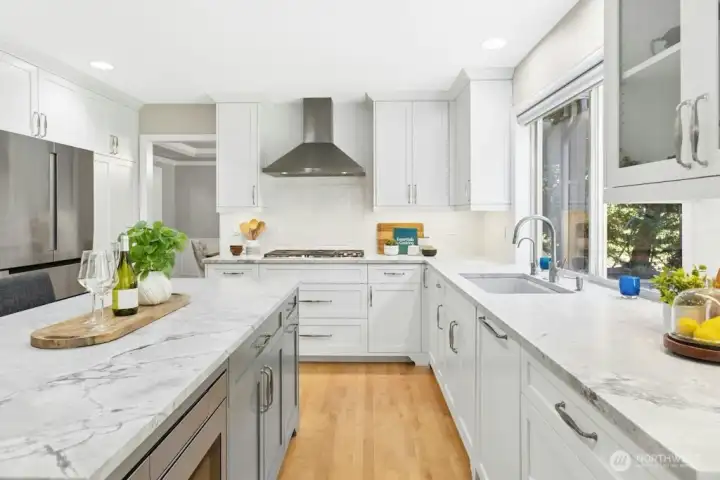 Stunning designer quartzite counters, And all updated cabinetry with slow close drawers and cabinets make this kitchen a chef’s delight!