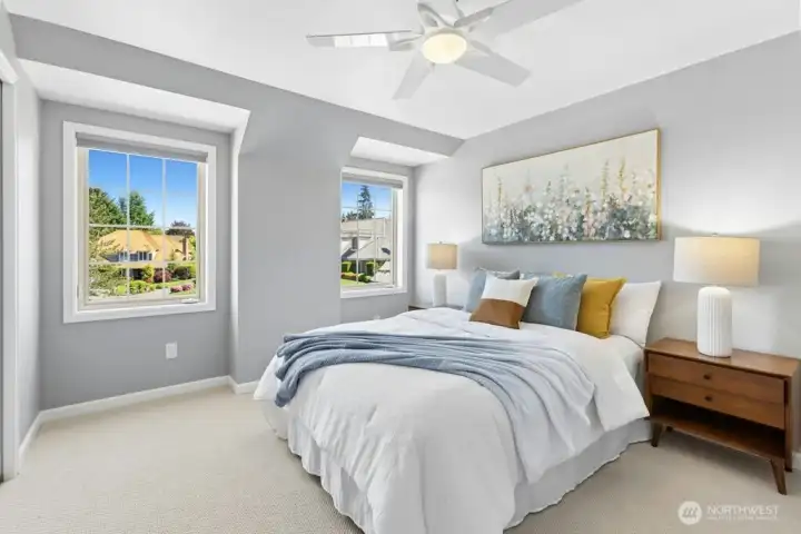 A large second bedroom with built-in closet organizers