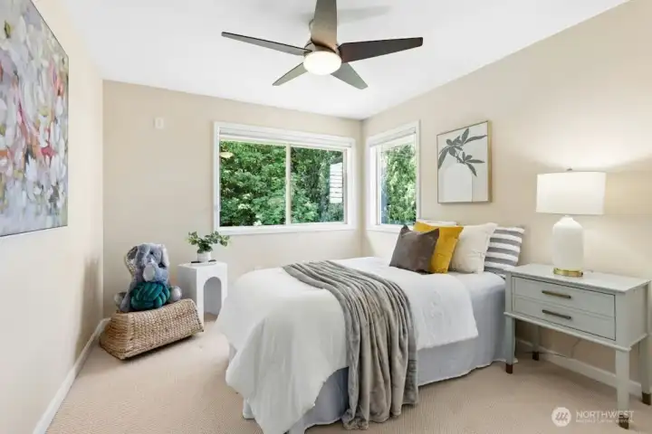 The fourth bedroom upstairs enjoys a view of the private backyard and includes plenty of space in the closet with built-in organizers