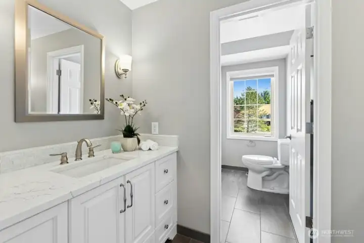 The main bathroom upstairs has been fully remodeled with marble countertops and natural stone flooring!