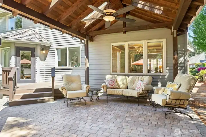 The covered patio area with ceiling fan/light provides plenty of entertaining space overlooking the private backyard!