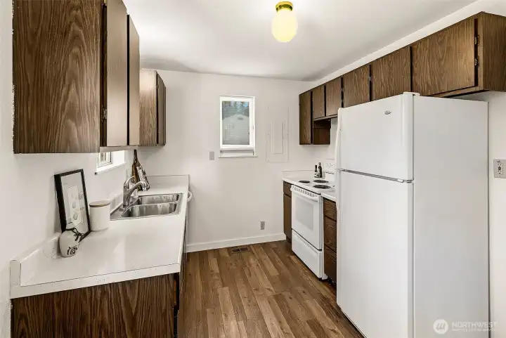 Galley kitchen  with a West facing window and new dishwasher.