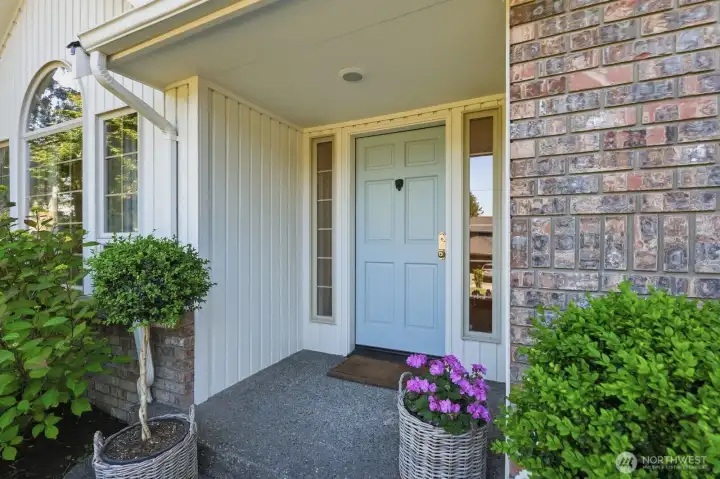 Charming covered front porch with French blue door.