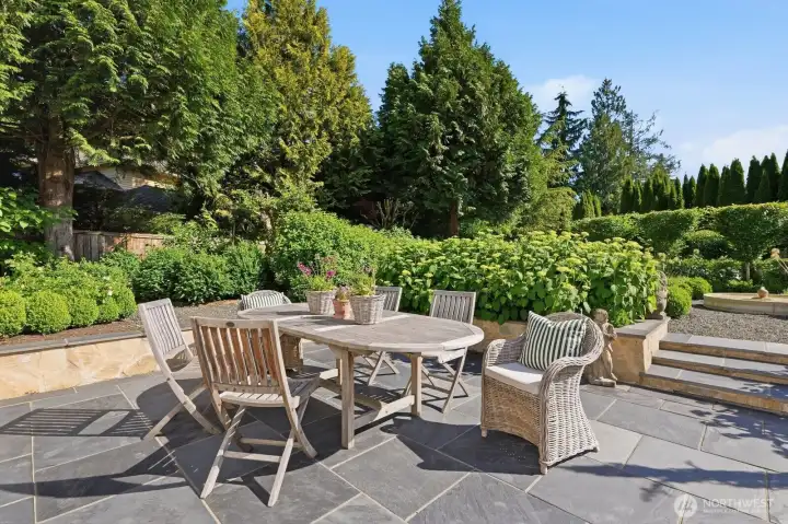 Beautifully landscaped backyard with a 600 sq/ft entertainment size stone patio, flagstone sit walls and drainage system.