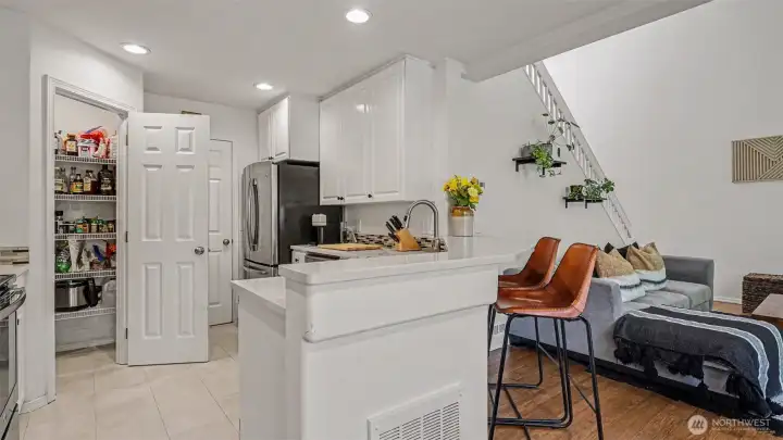 Light and bright kitchen with new vinyl plank flooring, stainless appliances and walk in pantry Light and bright kitchen with new vinyl plank flooring, stainless appliances and walk in pantry