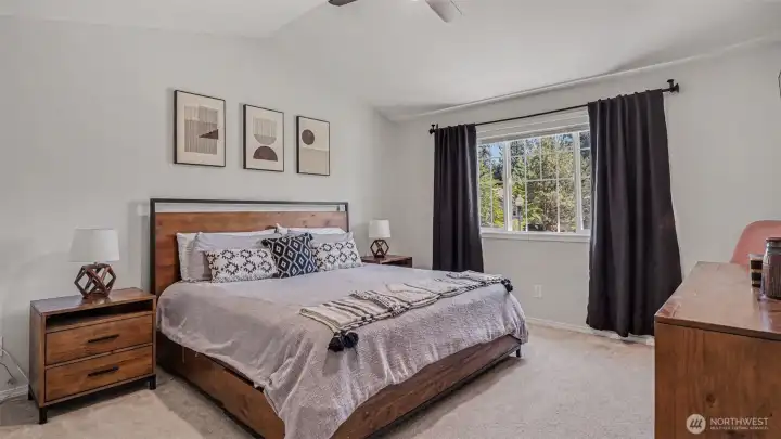Primary bedroom with vaulted ceiling & fan Primary bedroom with vaulted ceiling & fan