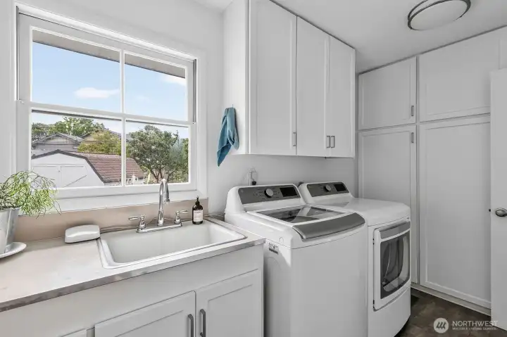 Laundry room with utility sink on main level with utility sink- another laundry room in basement!