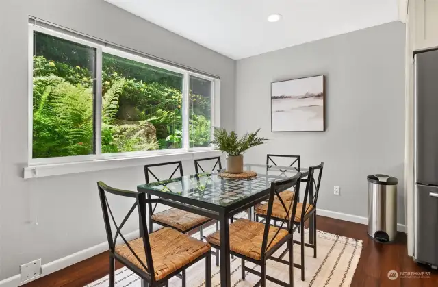 Look out to the outdoors through oversized windows in the dining area. Plenty of natural light fills the space for a bright and cheerful interior.