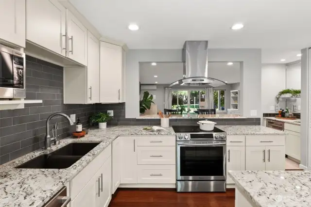 Stainless steel appliances blend harmoniously with grey subway tile for a modern flair.