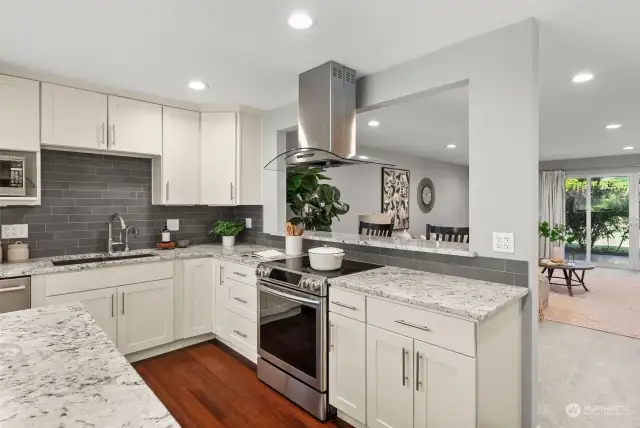 Floor to ceiling cabinetry provide ample space for all your kitchen essentials.  The pass through opening allows for entertaining while preparing food in the kitchen.